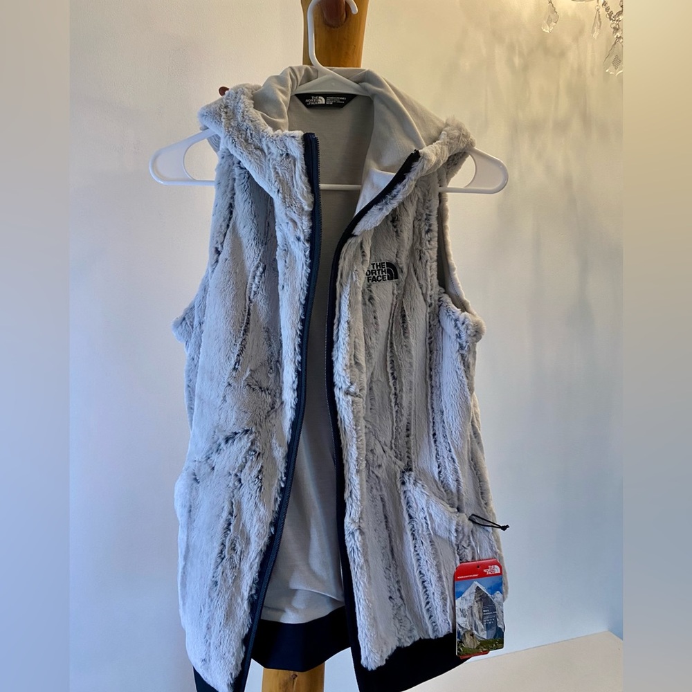Woman’s medium, zip up north face vest, grey with side zip up pockets.